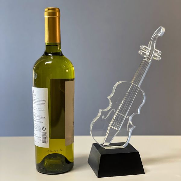Crystal Violin on Black Crystal Based Next to Wine bottle